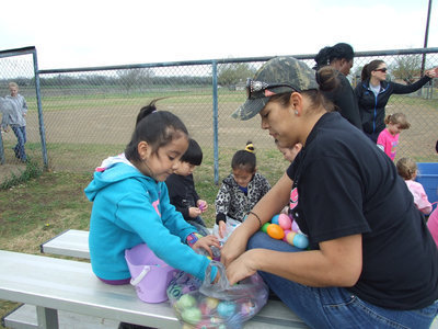 Image: The kids check out their bounty with a little help from their parents.