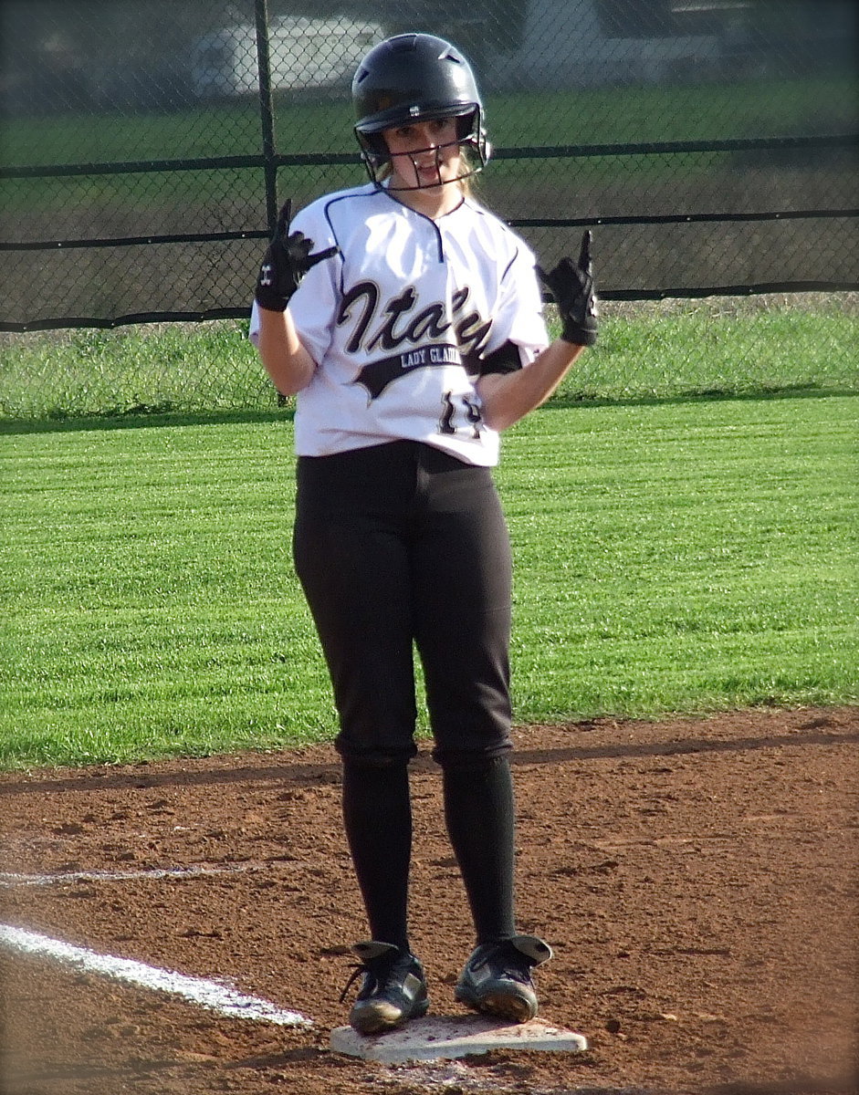 Image: Lady Gladiator Kelsey Nelson(14) is all jazzed after hitting a triple