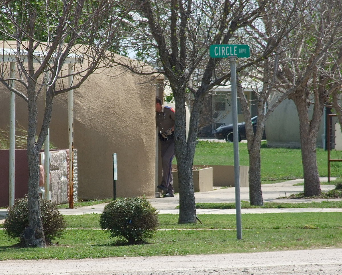 Image: A State Trooper searches dome structures not realizing he is just feet away from the bushes where the suspect would eventually be located and captured.