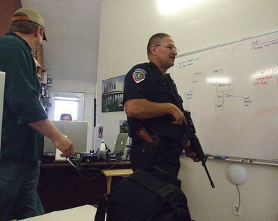 Image: Mike South escorts Milford Police Chief Carlos Phoenix in and around the dome -shaped structures during an armed search for a fleeing suspect.