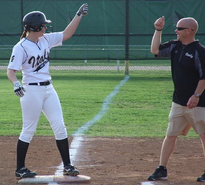 Image: Nice hit, Madison! First base coach Michael Chambers and Madison Washington(2) celebrate her hit.
