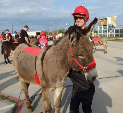 Image: DeeDee Hamilton, a member of the Arse-Kickers consisting of band members and supporting parents, poses with her teammate before entering the Italy Coliseum.