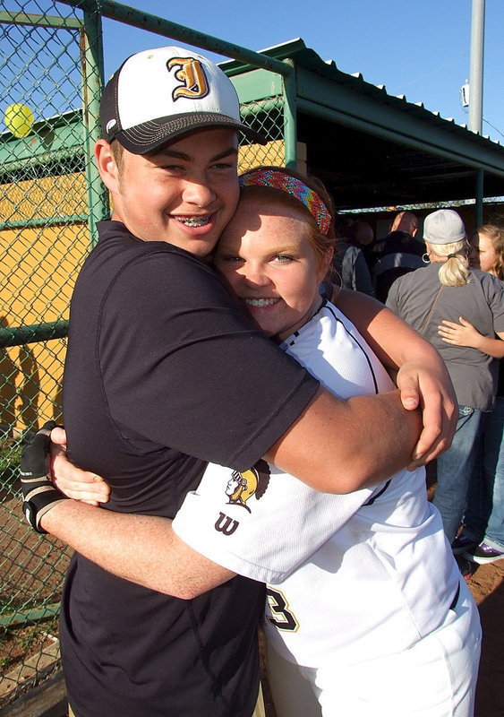 Image: Lady Gladiator senior Katie Byers(13) receives a hug from cousin Zain Byers as Katie and her fellow seniors partake in their final home games.