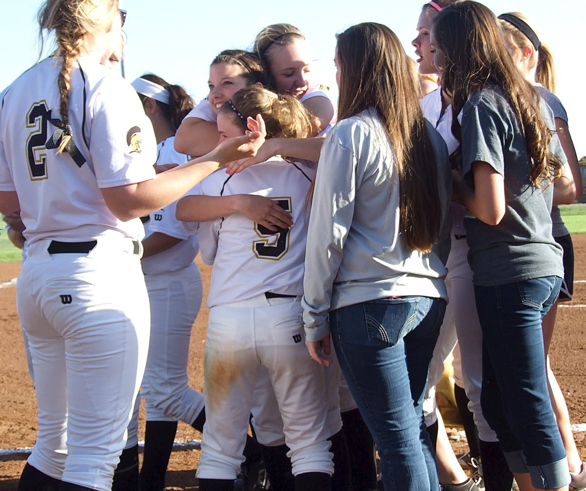 Image: Senior Morgan Cockerham(8) is mugged with hugs from all her teammates as Jaclynn Lewis(15) and Tara Wallis(5) squeeze tight.
