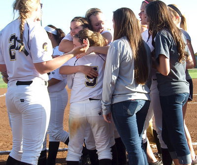 Image: Senior Morgan Cockerham(8) is mugged with hugs from all her teammates as Jaclynn Lewis(15) and Tara Wallis(5) squeeze tight.