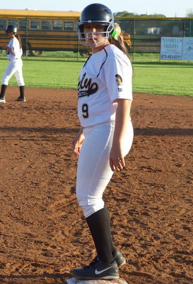 Image: Alyssa Richards(9) is safe at first while teammate Ashlyn Jacinto(7) advances to second base against Covington.