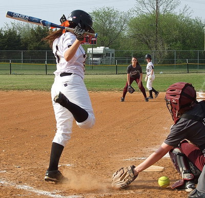 Image: Senior Lady Gladiator Morgan Cockerham(8) avoids a low pitch with teammate Tara Wallis(5) on first base.