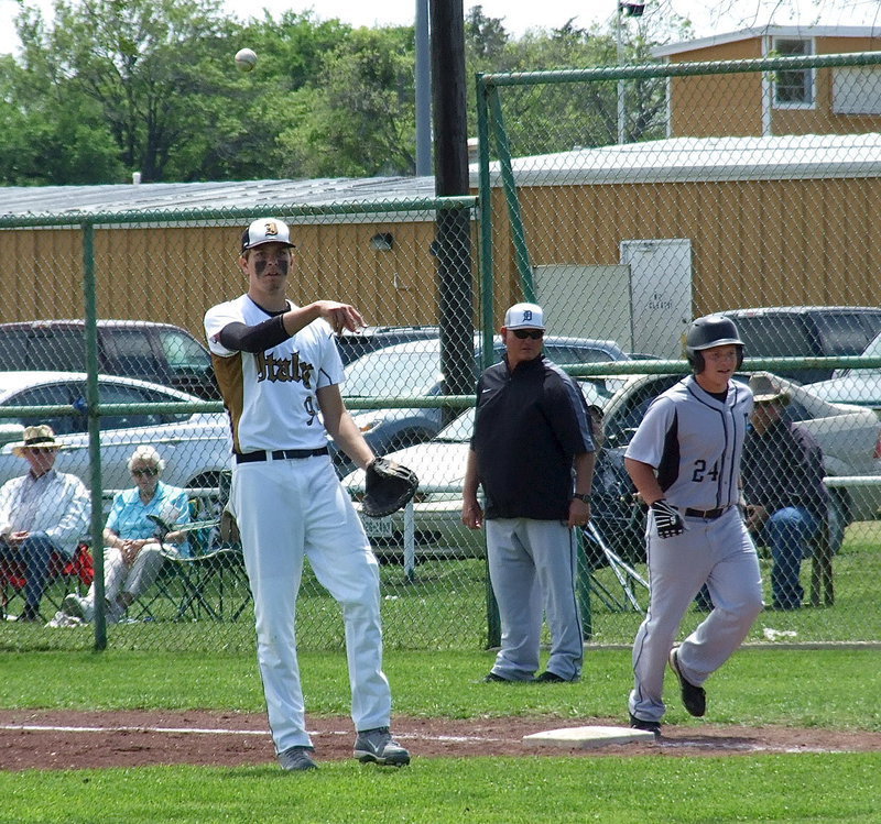 Image: Senior first baseman Cole Hopkins(9) returns the ball to the mound after securing the out at first base after a Dawson hit.