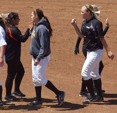 Image: Lillie Perry(12) and Jaclynn Lewis(15) show good sportsmanship after the warm-up game with Ferris.