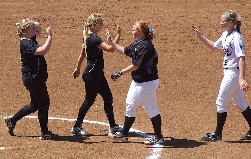 Image: Katie Byers(13) and Madison Washington(2) offer well wishes to Ferris players following Italy’s win.