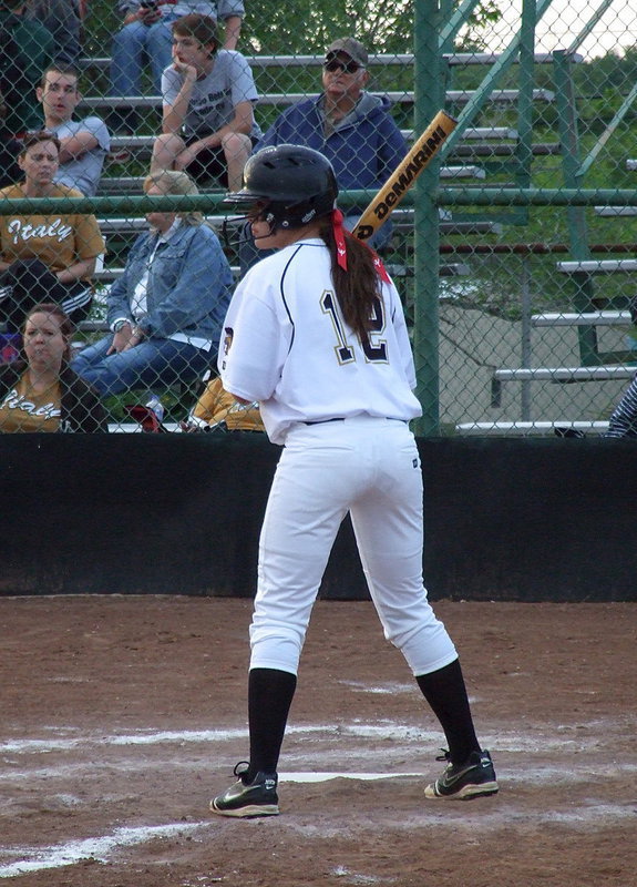 Image: Freshman Lillie Perry(12) hits and tries to reach first base against visiting Mildred.