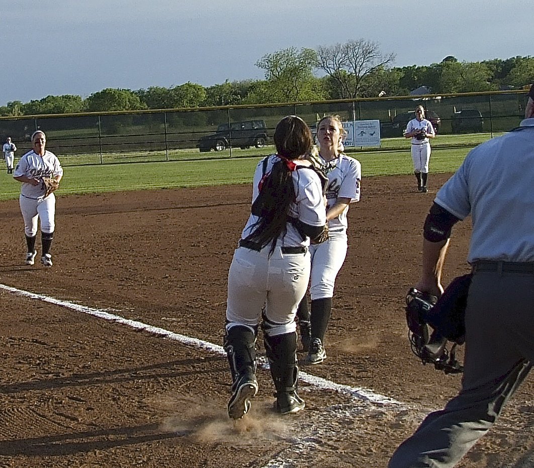 Image: Avoiding a collision with teammate Jaclynn Lewis(15) and still making the catch is senior catcher Alyssa Richards(15).
