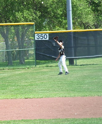 Image: Mason Womack(9) catches a fly ball to the deep left corner of Davidson Field.