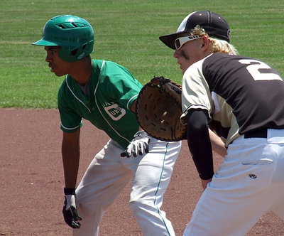 Image: Cody Boyd(2) holds a Clifton runner at first base.