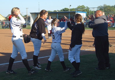 Image: Teammates Paige Westbrook(10) and Morgan Cockerham(8) congratulate Tara Wallis(5) after Wallis caught a fly ball hit to left field.