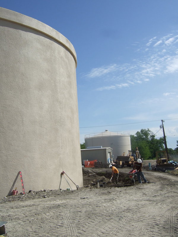 Image: Workers diligently working around the tank.