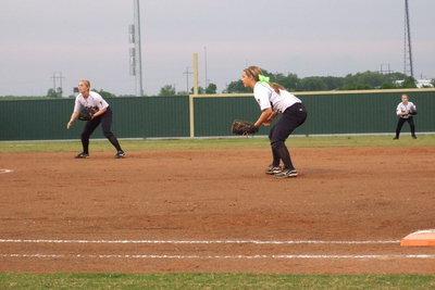 Image: Madison Washington(2), Bailey Eubank(1) and Tara Wallis(5) react to a Bosqueville hit.