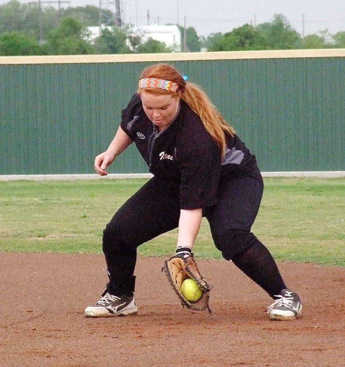 Image: Italy’s Katie Byers(13) practices fielding grounders before the game begins.
