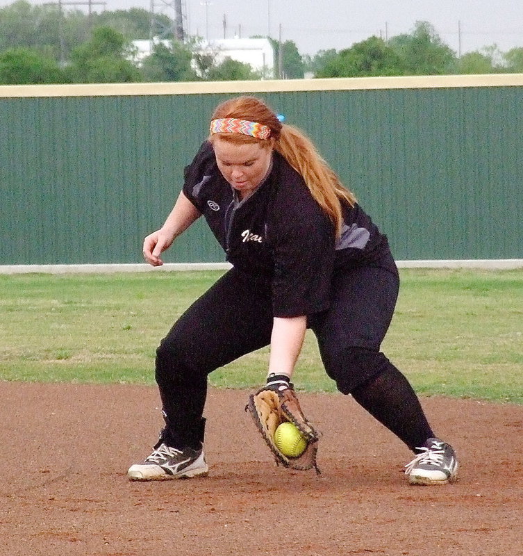 Image: Italy’s Katie Byers(13) practices fielding grounders before the game begins.