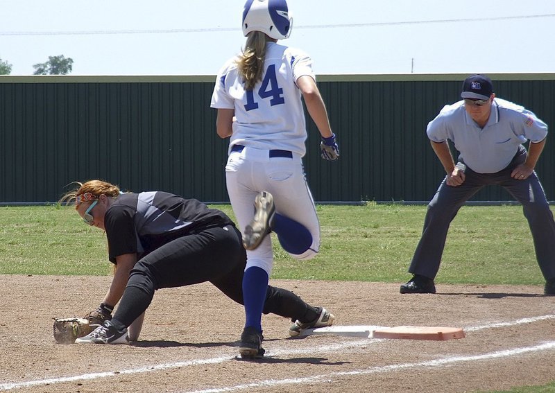 Image: First baseman Katie Byers digs the ball out of the sand in time to get a Bosqueville runner out.