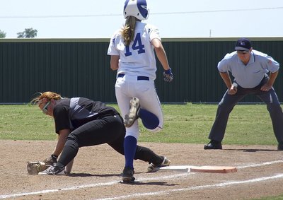 Image: First baseman Katie Byers digs the ball out of the sand in time to get a Bosqueville runner out.