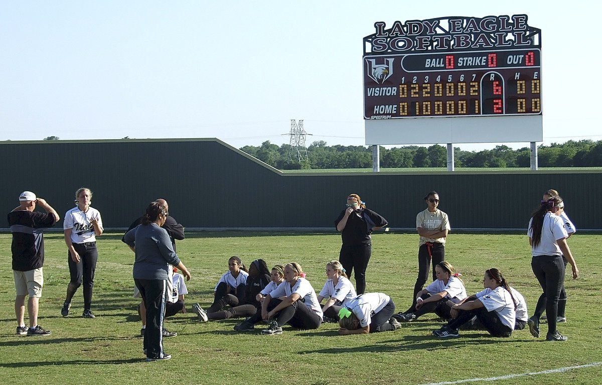 Image: The coaches address the Lady Gladiators after the game three loss to Bosqueville.