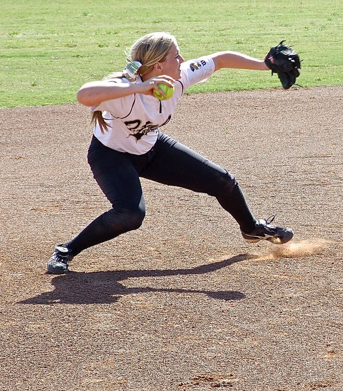 Image: Shortstop Madison Washington(2) snags a grounder and then rises into a throwing motion in an attempt to throw a Bosqueville runner out at first base.