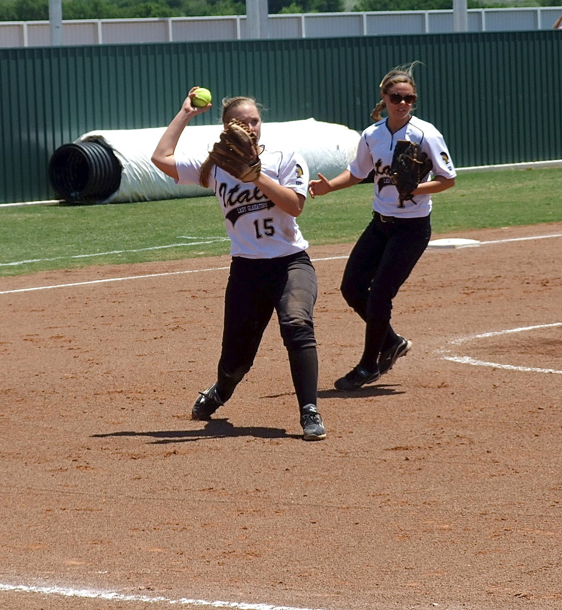 Image: With second baseman Bailey Eubank(1) backing up the play, Italy’s Jaclynn Lewis(15) covers a bunt toward the mound and then guns down a Bosqueville runnner at first base.