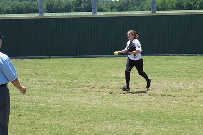 Image: Lady Gladiator right fielder Morgan Cockerham(8), a senior, makes the catch for an out and then runs the ball in towards the infield to hold runners on base.