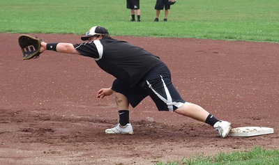 Image: John Byers stretching out at first base.