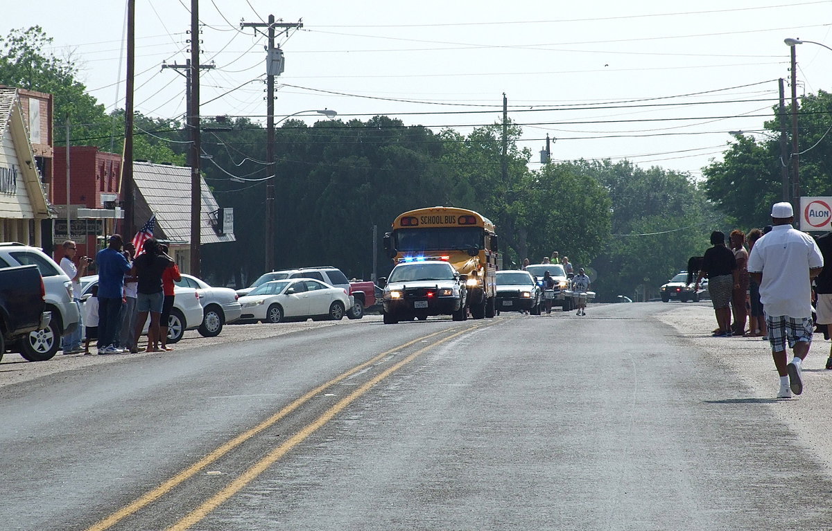 Image: Here they come! Gladiator fans begin to crank up the cheers as the sirens blare and the band plays to signal the parade has turned the corner and is approaching downtown Italy. Everyone awaits to cheer on the baseball boys who are heading to their playoff game in Forney, to congratulate the softball girls on their successful season and congratulate the track stars who did so well at the State meet in Austin.