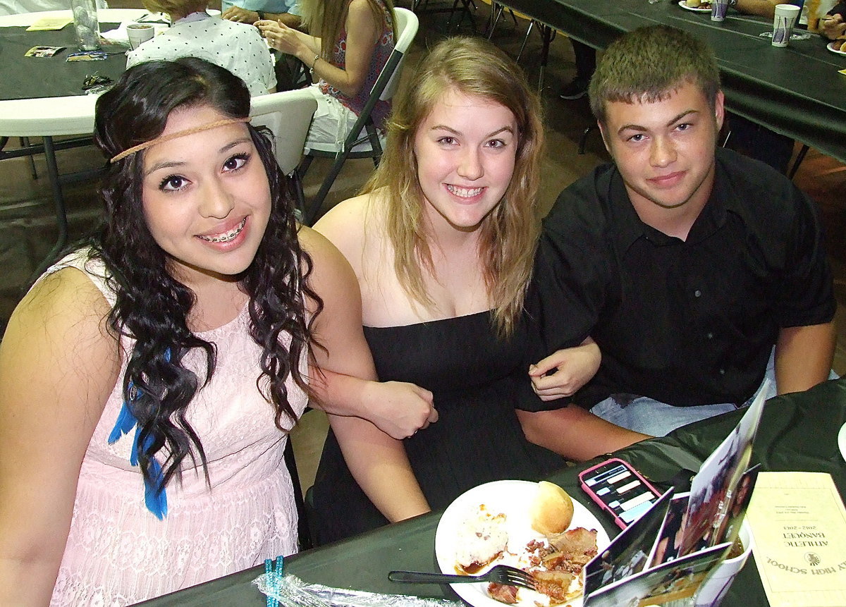 Image: Monserrat Figueroa, Taylor Turner and Zain Byers are enthralled by the suspense of the award presentations.