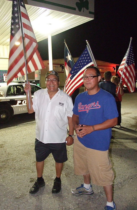 Image: Jessie Castro and his son, Emanuel Castro, are ready for Birdman’s arrival with the heroic jogger about a half mile away from arriving at the Italy checkpoint.