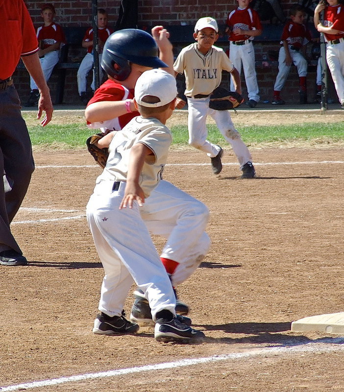 Image: Italy Gold’s Gavin Ramirez(6) tags a Maypearl runner out at third base as teammate, Jalyn Wallace(1), approves of the result.