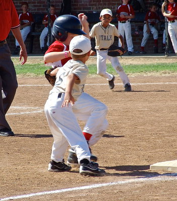 Image: Italy Gold’s Gavin Ramirez(6) tags a Maypearl runner out at third base as teammate, Jalyn Wallace(1), approves of the result.
