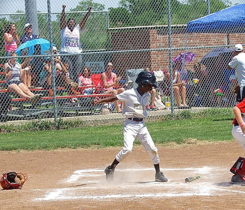 Image: Stepping on home plate to complete his home run is Italy White’s, John Hall(9), as his mother, Latoya Hall, celebrates in the stands.