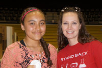 Image: Mrs. Thompson gives Vanessa the first place ribbon for the Science Fair.