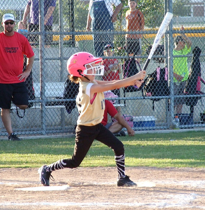 Image: Italy’s Paige Little connects on the ball for a base hit.