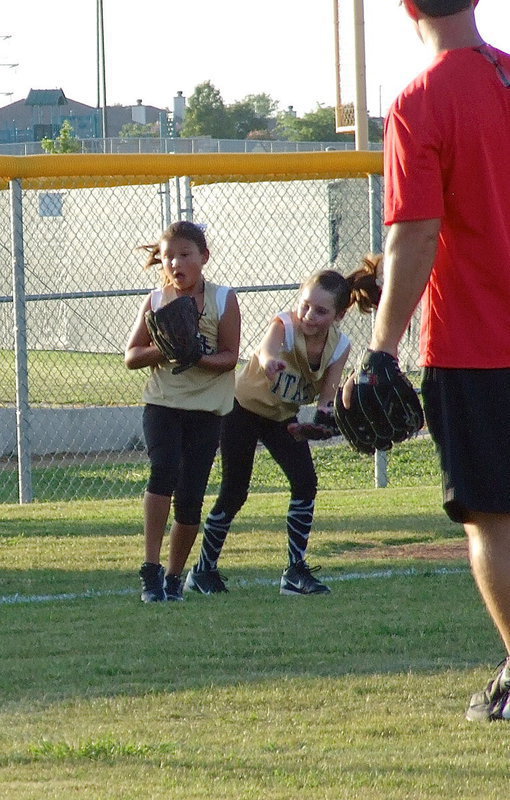 Image: Third baseman, Cadence Ellis avoids a collision with pitcher, Emily Janek, to make the catch for an out against Waxahachie.