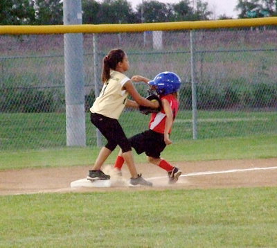 Image: Making the tag for an out against Waxahachie is Italy’s third baseman, Cadence Ellis.