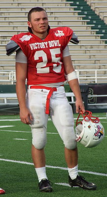 Image: Representing Avalon High School, the Avalon Eagle Football program and the FCA Victory Bowl V Red Team All-Stars is Reece Marshall, who is introduced to Floyd Casey Stadium during a halftime presentation.