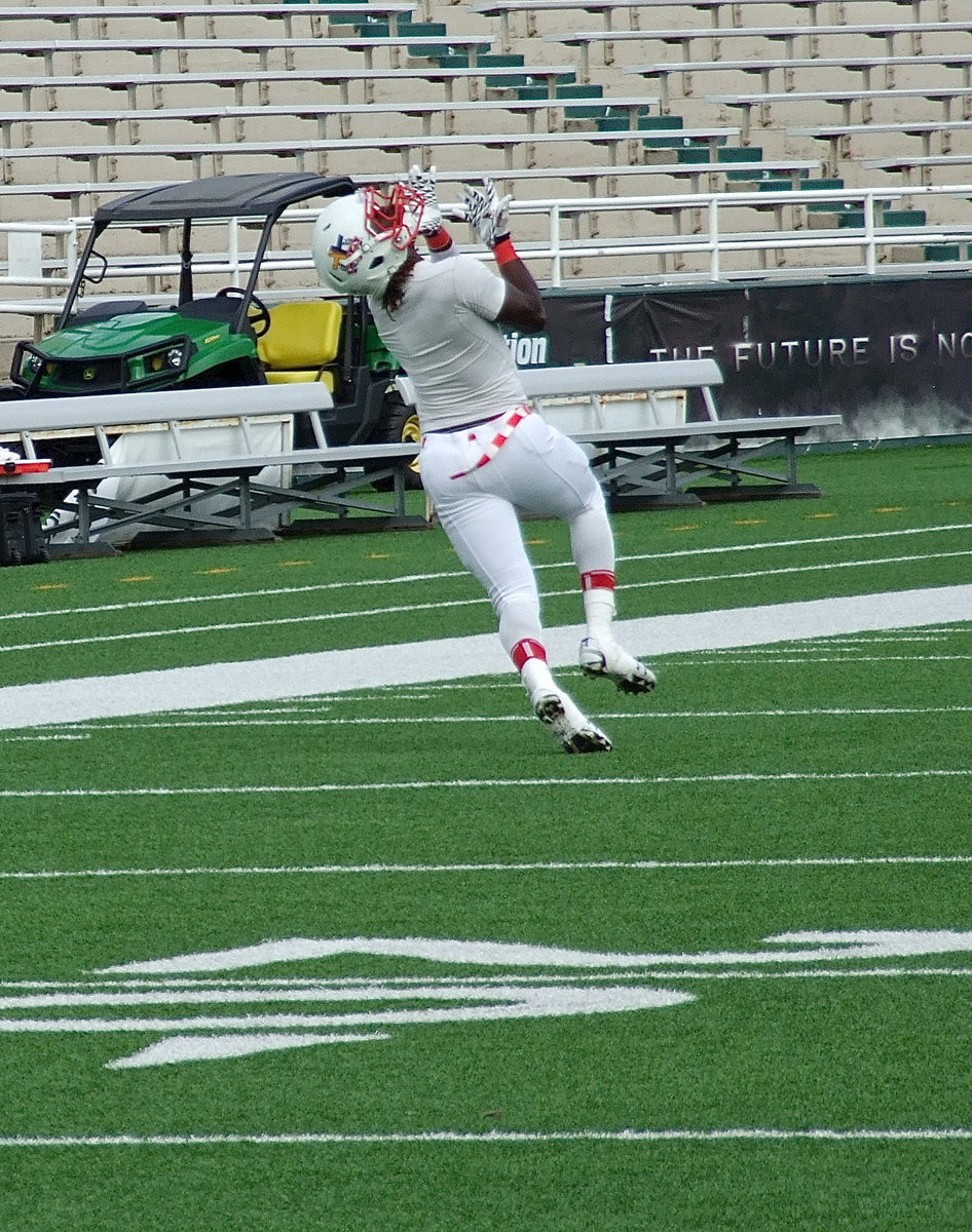 Image: Italy’s Ryheem Walker hauls in a deep pass during the pre-game warmup.