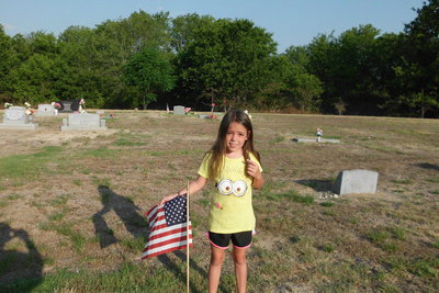 Image: Morgan Chambers learns community service at the Italy Cemetery.