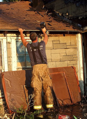 Image: Forreston firefighter, Bobby McBride, uses a thermal imaging camera to record the damage.