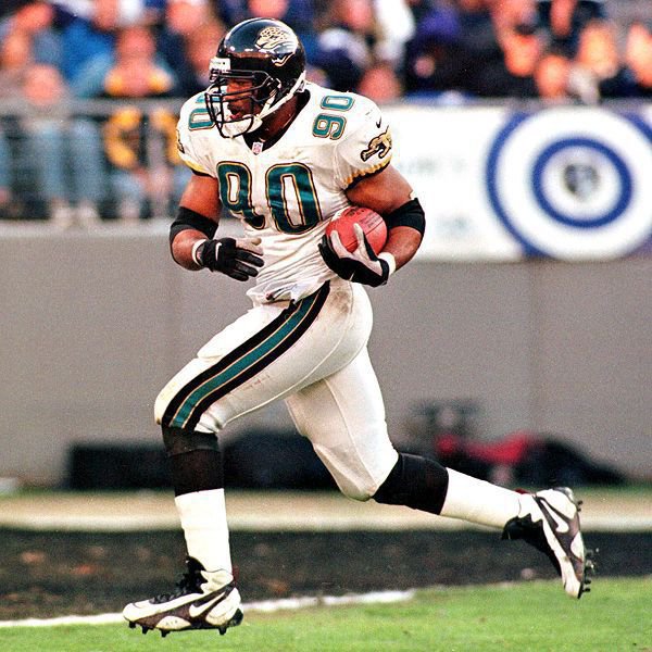 Image: Defensive End Tony Brackens, 90, scoring a defensive touchdown for the Jacksonville Jaguars.