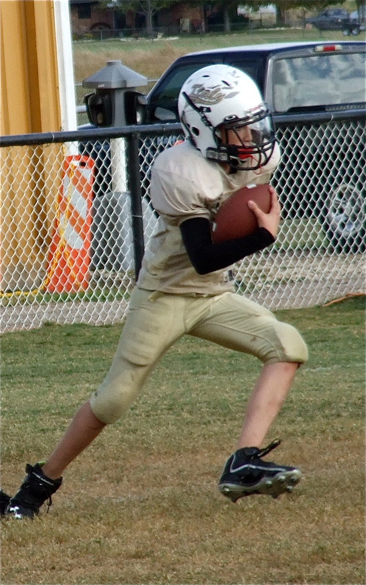 Image: A-Team quarterback Ryder Itson(2) tries to make something happen for Italy.