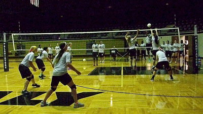 Image: Sophomore Halee Turner and senior Paige Westbrook combine for the block attempt, with Bailey Eubank backing them up, as the varsity gets challenged.