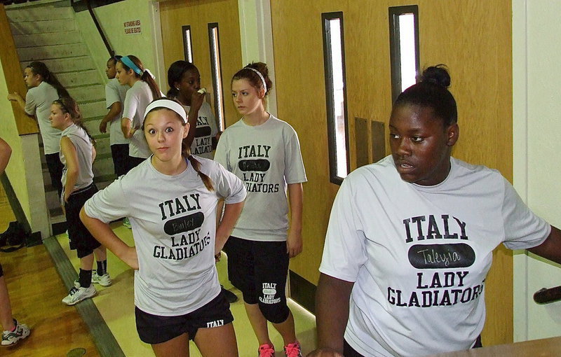 Image: Bailey Eubank (jr.), Brook DeBorde (fr.) and Taleyia Wilson (so.) prepare to run stairs inside the double-decked Italy Coliseum.