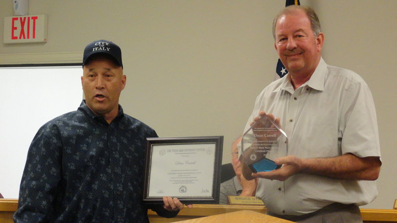 Image: Mayor James Hobbs presents Dean Carrell, public works director, with a glass plaque and certificate from Texas A&M University naming him a Certified Water Professional.