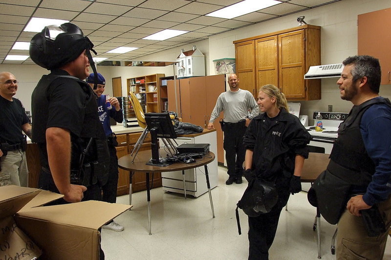 Image: Officers share a light moment before the intensity picks up during a rescue simulation drill.